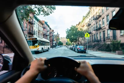 First driving lesson from driver's seat perspective on quiet Brooklyn residential street